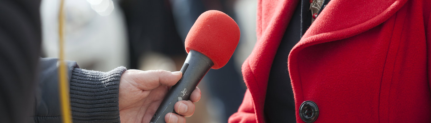 An interviewer holding a microphone