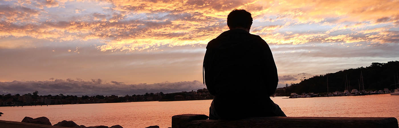 Man thinking at sunrise