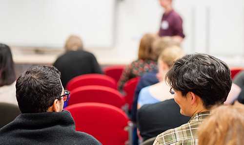 people talking at event photographed from behind