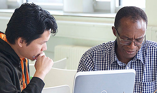 student and supervisor at laptop