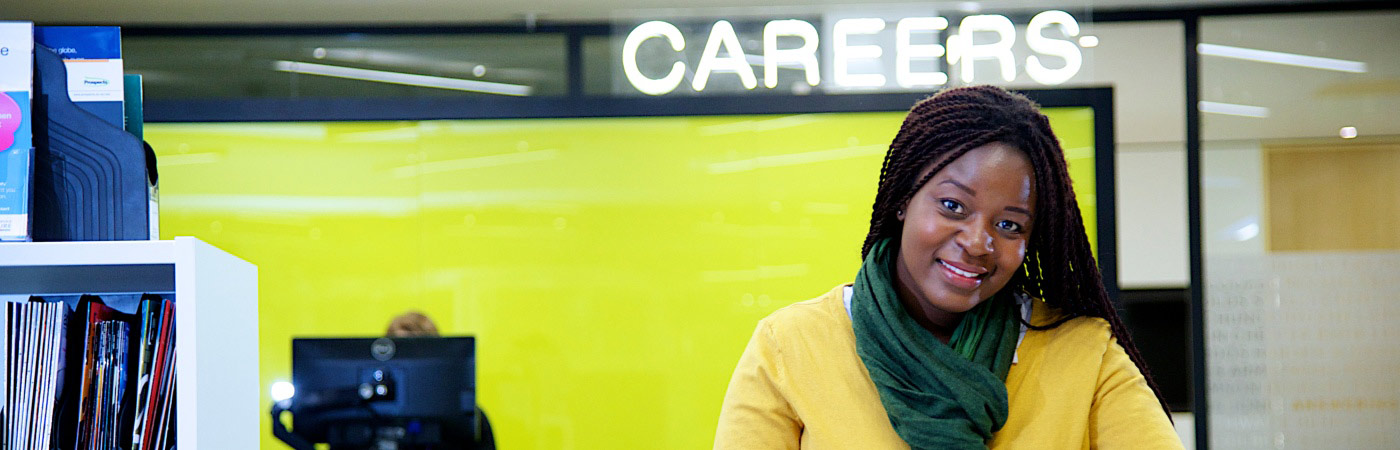 Student stood in front of the careers sign 