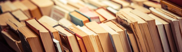 Many old books in a book shop or library.