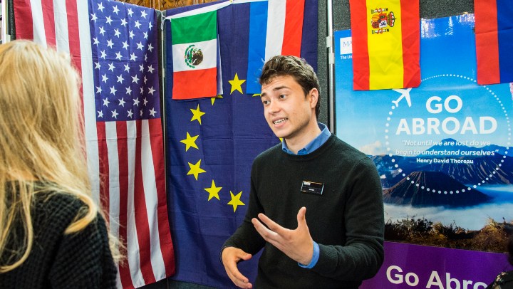 Staff member speaking at a study abroad fair 