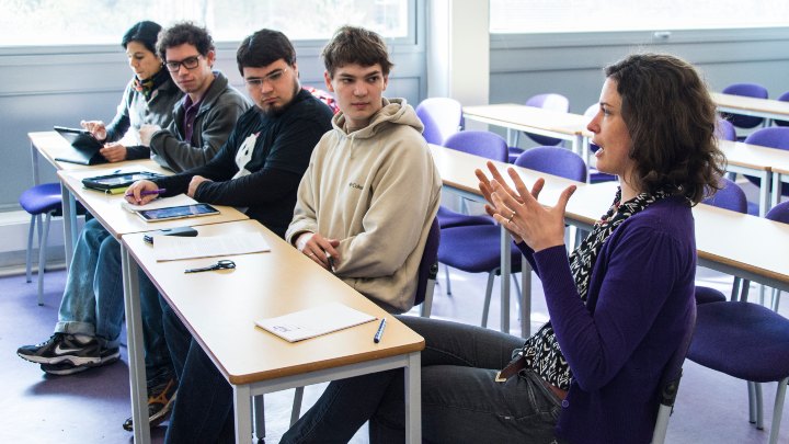 Supervisor talking to students in a classroom