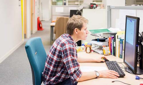 Postgraduate researcher at desk