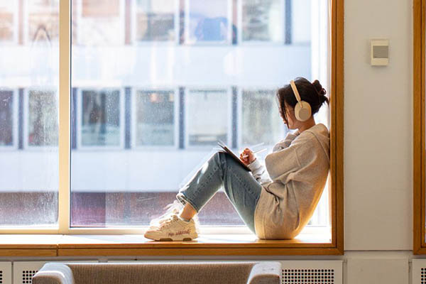 Student sat on a window ledge